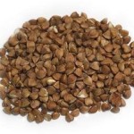 handful of buckwheat on white background
