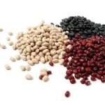 Dry white, red, and black beans on white background
