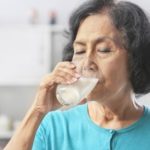 an-older-lady-drinking-a-glass-of-milk