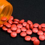 a-bottle-of-red-pills-spilling-out