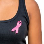 close-up-of-woman-s-torso-wearing-breast-cancer-ribbon