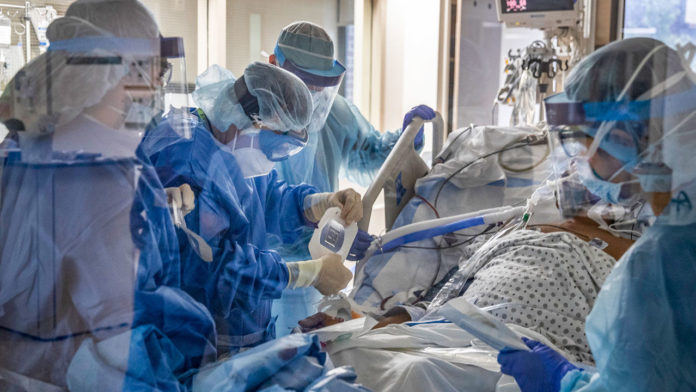 Dr. James Gasperino, background center, chief of medicine and critical care, at the Brooklyn Hospital Center in New York, March 30, 2020. (Victor J. Blue/The New York Times)