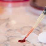 Laboratory doctor or scientific researcher preparing for a smear