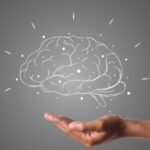 brain writes with white chalk is on hand, draw concept.