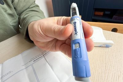 Hand-Holding-Blue-GLP-1-Semaglutide-Ozempic-Pen-Close-Up-1200x800